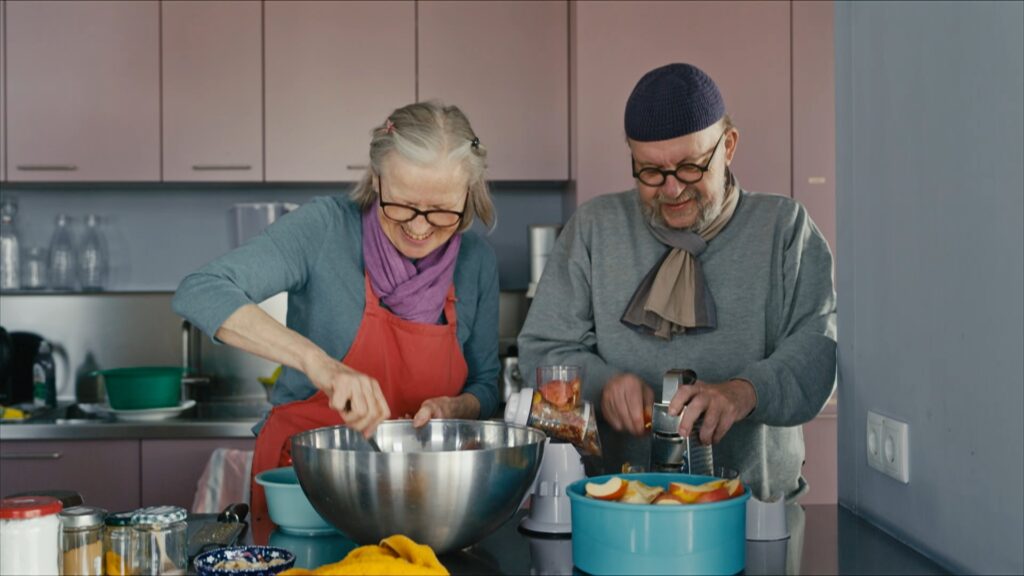 Two residents of WG Melange cooking together